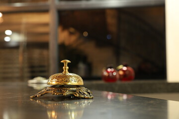 Bell on wood for service with blurred wooden background.