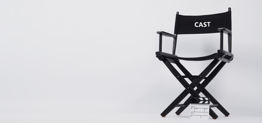 Black director chair with word cast and small white  clapper board on white background.