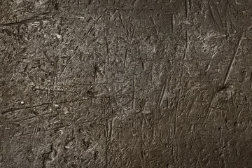 Rough metal surface with scratches and dents.