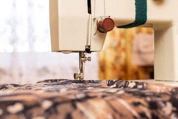 sewing machine and needle. Hobby sewing. Sewing machine on table in tailor's workshop