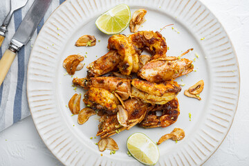 Roasted tiger prawns with Mango chutney and crispy garlic, on plate, on white background, top view flat lay