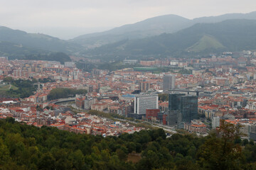 Fototapeta na wymiar Bilbao seen from a hill in a cloudy day