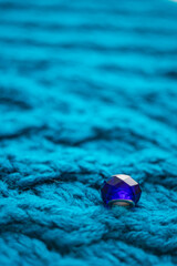 Blue crystal on a pale blue knitted table