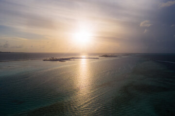 Fantastic Maldivian uninhabited islands on the sunrise. July 2021, aerial drone picture.