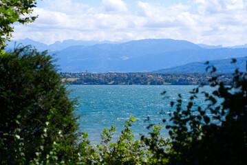 Panoramic landscape at Nyon with Lake Geneva and European Alps in the background. Photo taken August 28th, 2021, Nyon, Switzerland.
