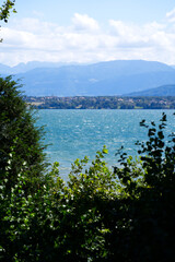 Panoramic landscape at Nyon with Lake Geneva and European Alps in the background. Photo taken August 28th, 2021, Nyon, Switzerland.