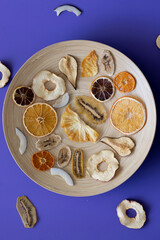 Healthy vitamins in dried fruits Wooden plate for food on background