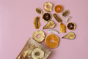 Dried fruits Colored blue background Useful vitamins Kiwi Coconut Pear Orange Banana Mandarin Lime