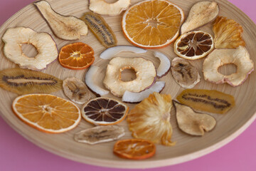 Fototapeta na wymiar Healthy vitamins in dried fruits Diet food Wooden plate for food on the background