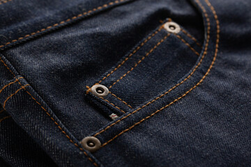 Textile of classic blue jeans with pocket close up.