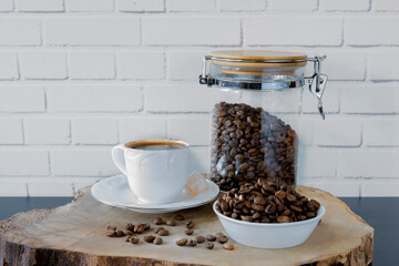 A cup of Turkish coffee and beans on a piece of wood. Selective focus 