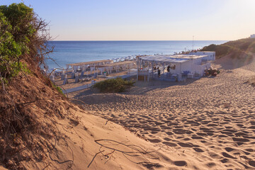 Typical sandy beach with dunes in Puglia, Italy: the beach of San Pietro in Bevagna, a natural oasis in front of the blue Ionian sea, stretches for several kilometres with crystal clear water.