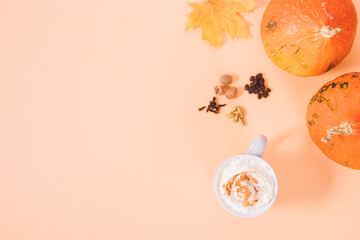 Cup of pumpkin spice latte next to cardamom