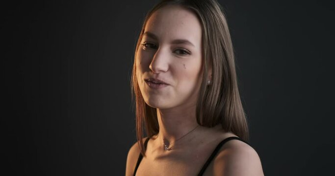 Teen girl with braces. Close up studio portrait of the smiling caucasian teen model with dental braces