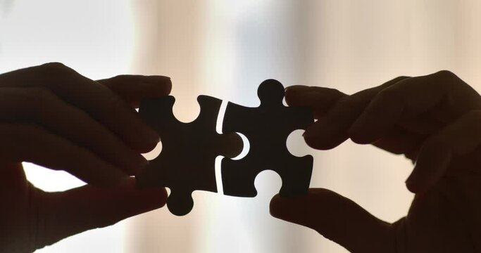 Close Up Hands of Woman Connecting Jigsaw Puzzle With Sunlight Affect. Business Solutions, Success Strategy. Two Hands Connect Couple Puzzle. One Part of Whole Symbol of Association and Connection.