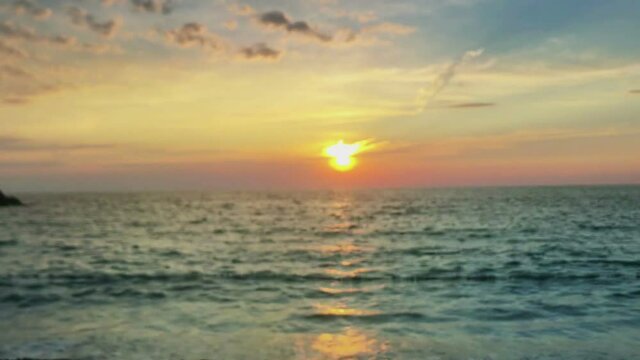 hand holding magic crystall ball over beautiful nature landscape on sunset, travel concept