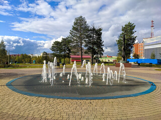 Noyabrsk, Russia - September 5, 2021: Central city fountain. Jets of water play in the sun. City view.