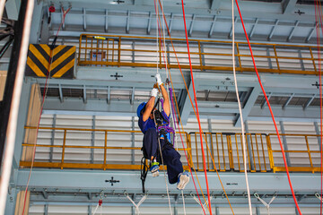 Male worker training rope access