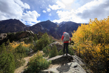 Fototapeta na wymiar Backpacker hiking in high altitude winter mountains