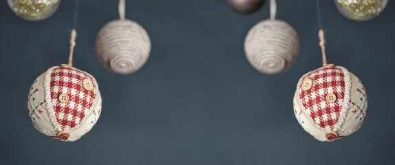 Christmas bauble with handcrafted decorations, swinging hanging wishing a merry christmas, on a gray background