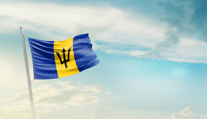 Barbados national flag cloth fabric waving on the sky with beautiful sun light - Image