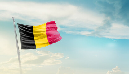 Belgium national flag cloth fabric waving on the sky with beautiful sun light - Image