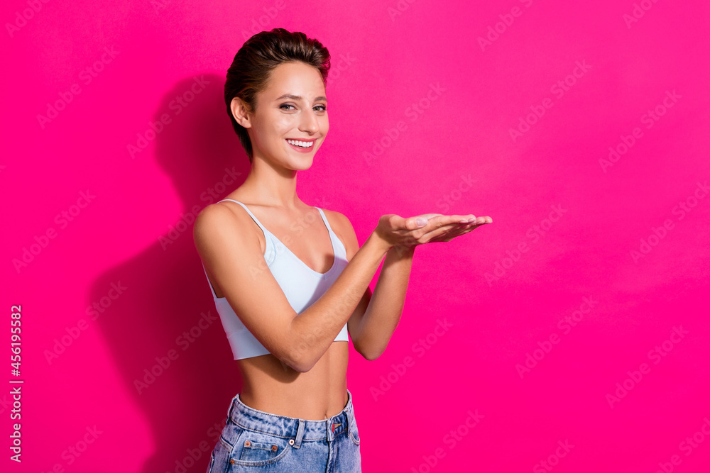 Poster Profile side view portrait of attractive cheerful girl holding on palm copy space isolated over bright pink magenta color background