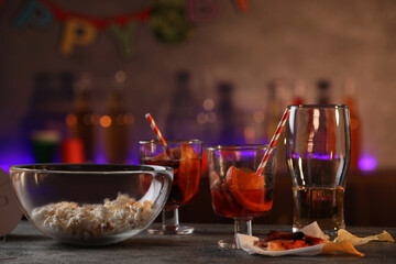 Messy table with drinks and food leftovers indoors. After party chaos