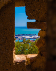 Beautiful view of the sea through the historic window at the castle of Gibralfaro in Malaga