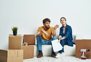 married couple moving boxes with things unpacking interior