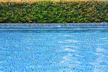 Fototapeta na wymiar Blue water and edge of swimming pool
