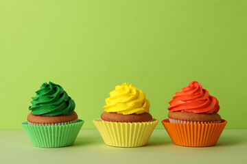 Obraz na płótnie Canvas Different delicious cupcakes on color background, space for text