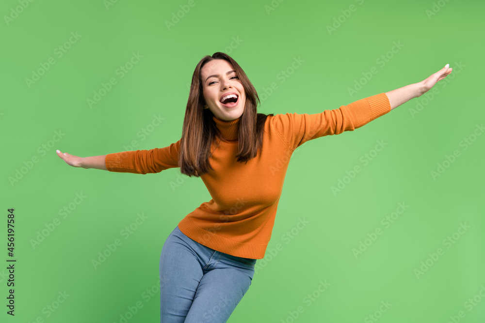 Poster portrait of attractive cheerful funny girl having fun dancing like plane clubbing isolated over gree