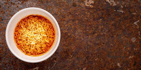 hot and sour noodle soup, Tom Yum shrimp flavor in white ceramic bowl on rusty texture background with copy space for text, Tom Yum Goong, Tom Yum Kung, Thai food