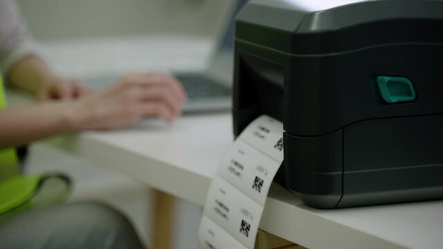 Employees are printing QR codes to attach products to the warehouse.
