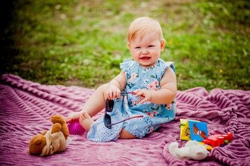 little girl laughing with glasses in nature