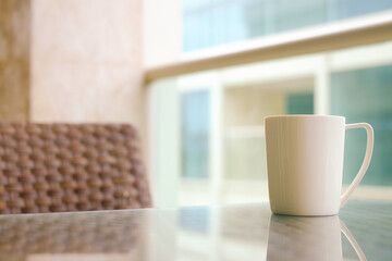 Fototapeta na wymiar white coffee cup with outdoor view