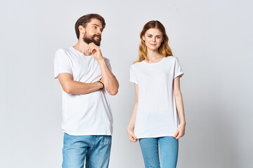 man and woman in white t-shirts studio fashion posing fun light background