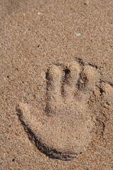 Fototapeta na wymiar handprint on sand