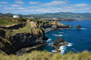 Fototapeta na wymiar Panoramic view of Northern coast of Sao Miguel Island (Azores, Portugal) close to Fenais da Luz with the Hermitage of Saint Peter, or Ermida de Sao Pedro, on a sunny day