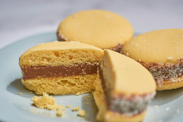 Traditional Argentinian alfajores with dulce de leche on marble table. Argentine gastronomy concept.