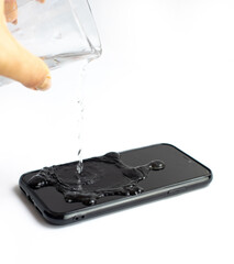 A wet black smartphone in white background