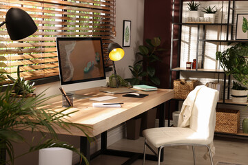 Light room interior with comfortable workplace near window