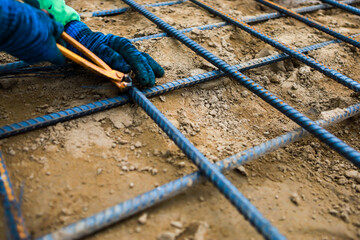 Construction worker Making Reinforcement steel rod and deformed bar with rebar at construction site.