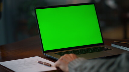 Fototapeta na wymiar Green screen laptop computer closeup. Unknown senior man having video call 