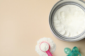 Flat lay composition with powdered infant formula on beige background, space for text. Baby milk