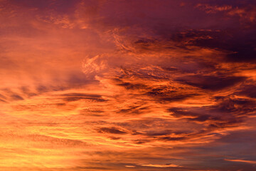 Naklejka na ściany i meble Beautiful fiery orange sky and clouds after the sunset