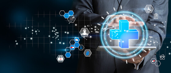 Businessman holding the icon of the more as a concept of health, medical insurance and personal status.