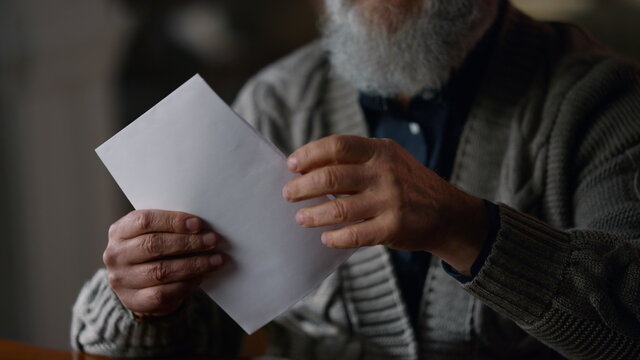 Happy Old Gentleman Receiving Letter In Cabinet. Glad Man Opening Envelope House