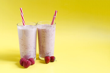 Milkshakes with red berries on a light background, a place for text. Cocktails made of ice cream, milk and berries close-up